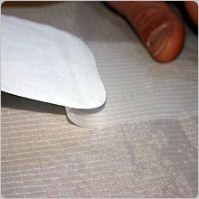 Keep easing off the backing paper till the patch is completely stuck down, make sure there are no air bubbles.